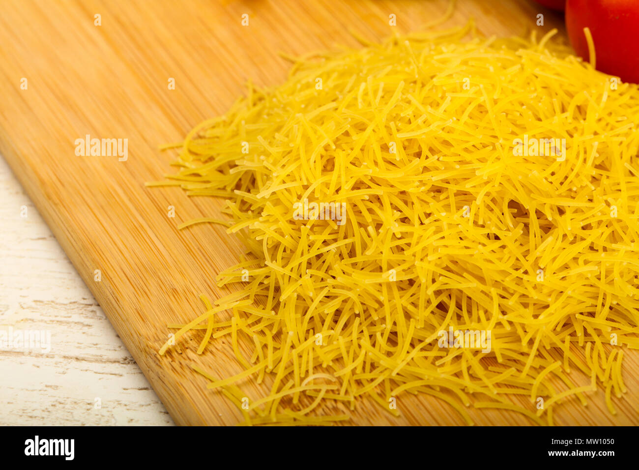 Raw noodle ready for bowling over wooden background Stock Photo