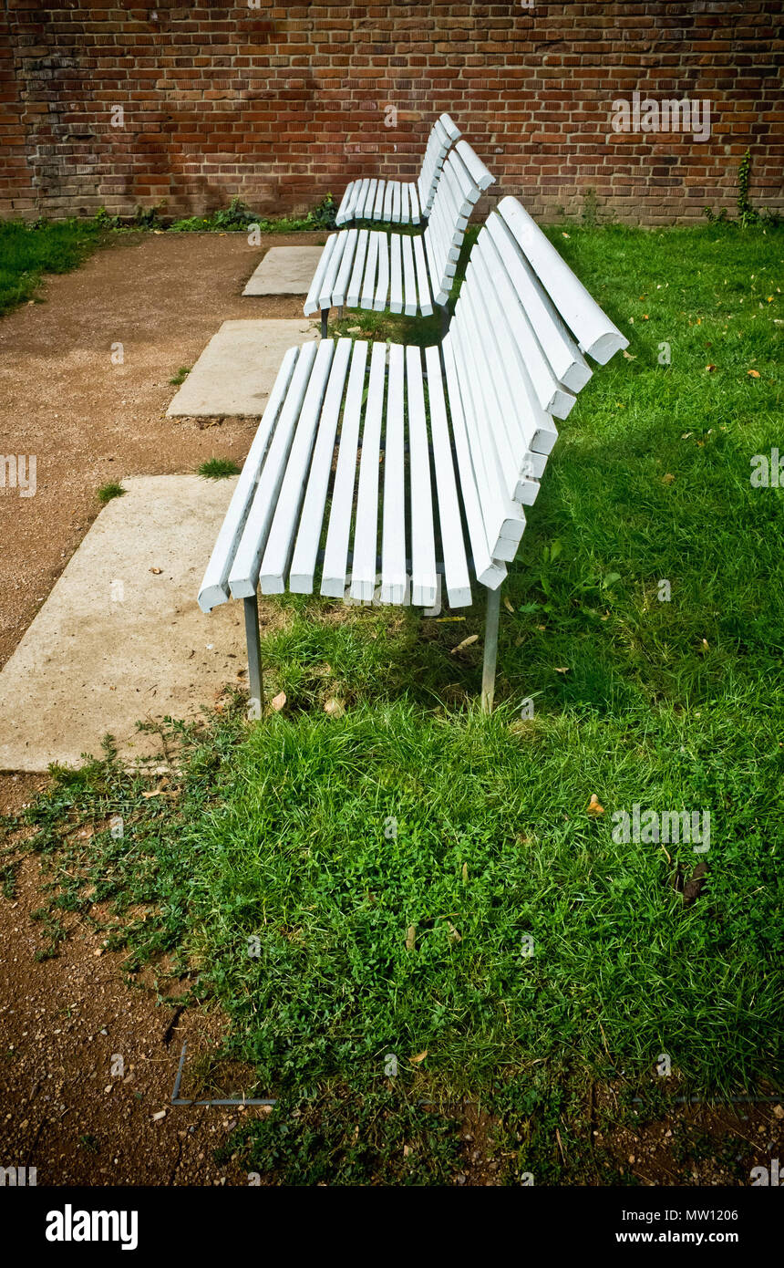 three empty white benches Stock Photo - Alamy