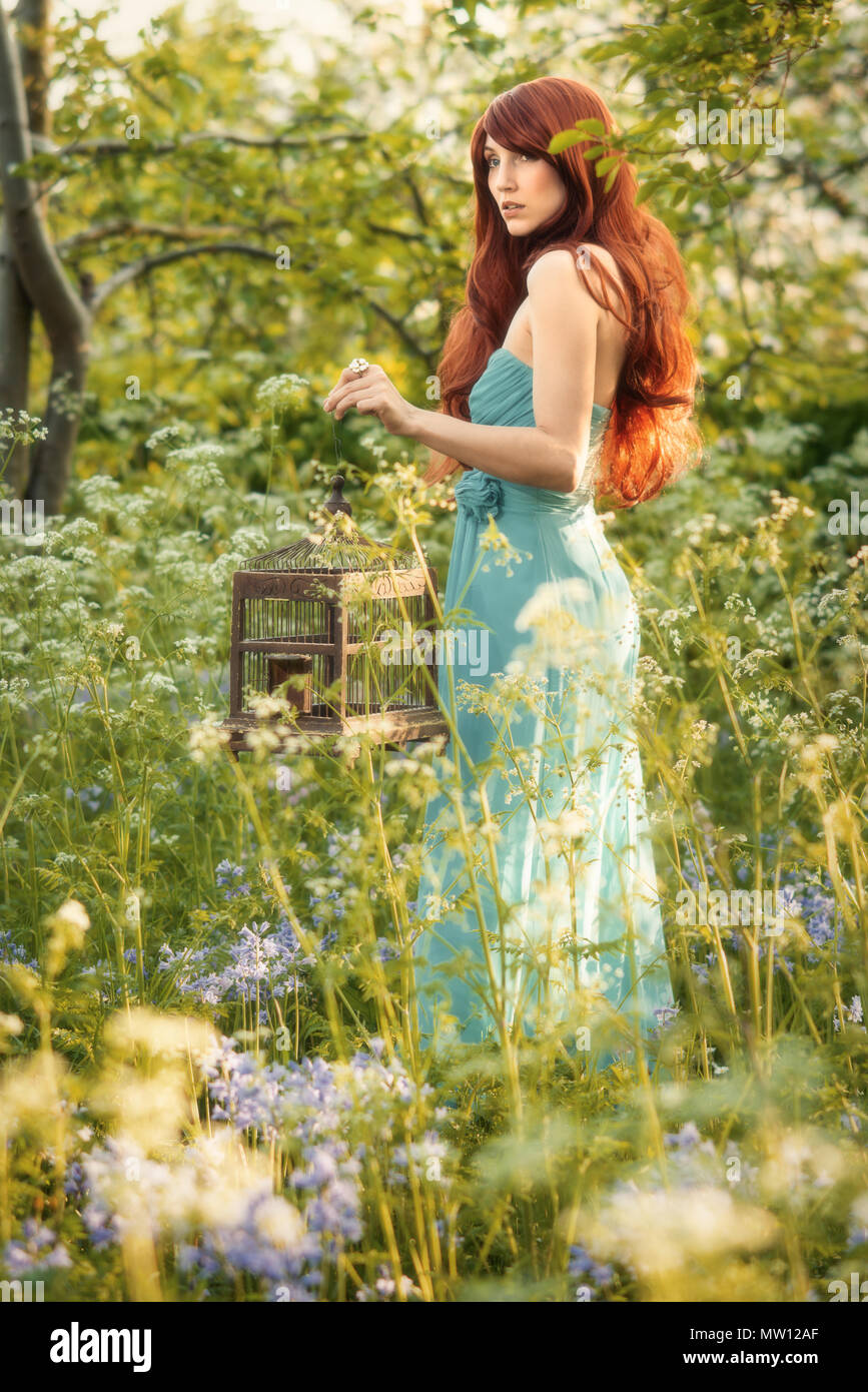 Woman with long red hair in Spring blossom Stock Photo