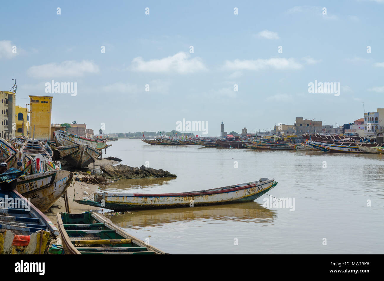 St Louis, Senegal - October 12, 2014: Colorful painted wooden fishing boats or pirogues at coast of St. Louis. Stock Photo