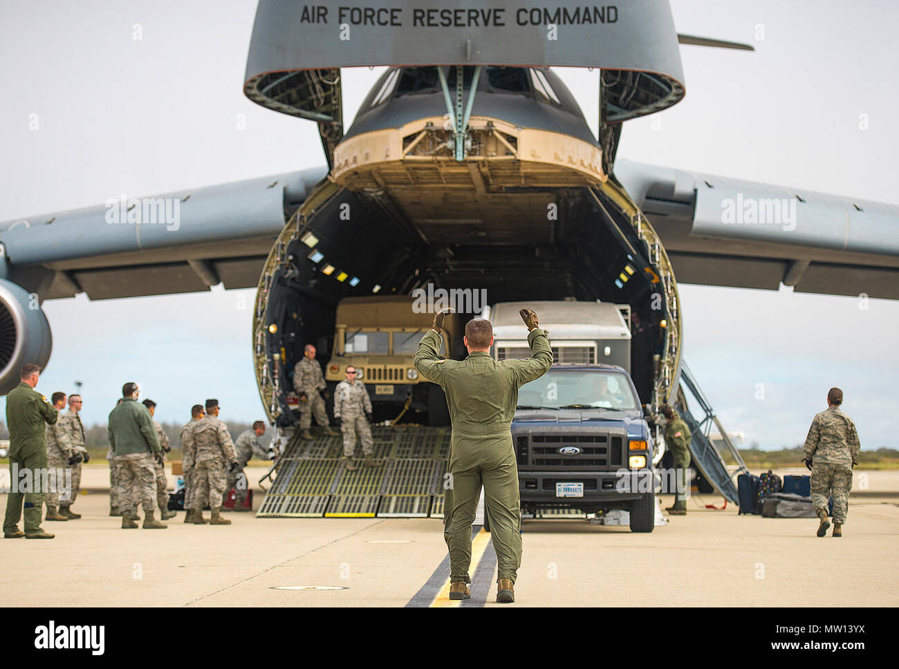 Airmen with the 68th Airlift Squadron unload vehicles from a C-5M Super Galaxy aircraft during exercise Patriot Hook April 26, 2017 at Vandenberg Air Force Base, California. Patriot Hook is an annual joint-service exercise coordinated by the Air Force Reserve, designed to integrate the military and first responders of federal, state and local agencies by providing training to mobilize quickly and deploying in military aircraft in the event of a regional emergency or natural disaster. Stock Photo