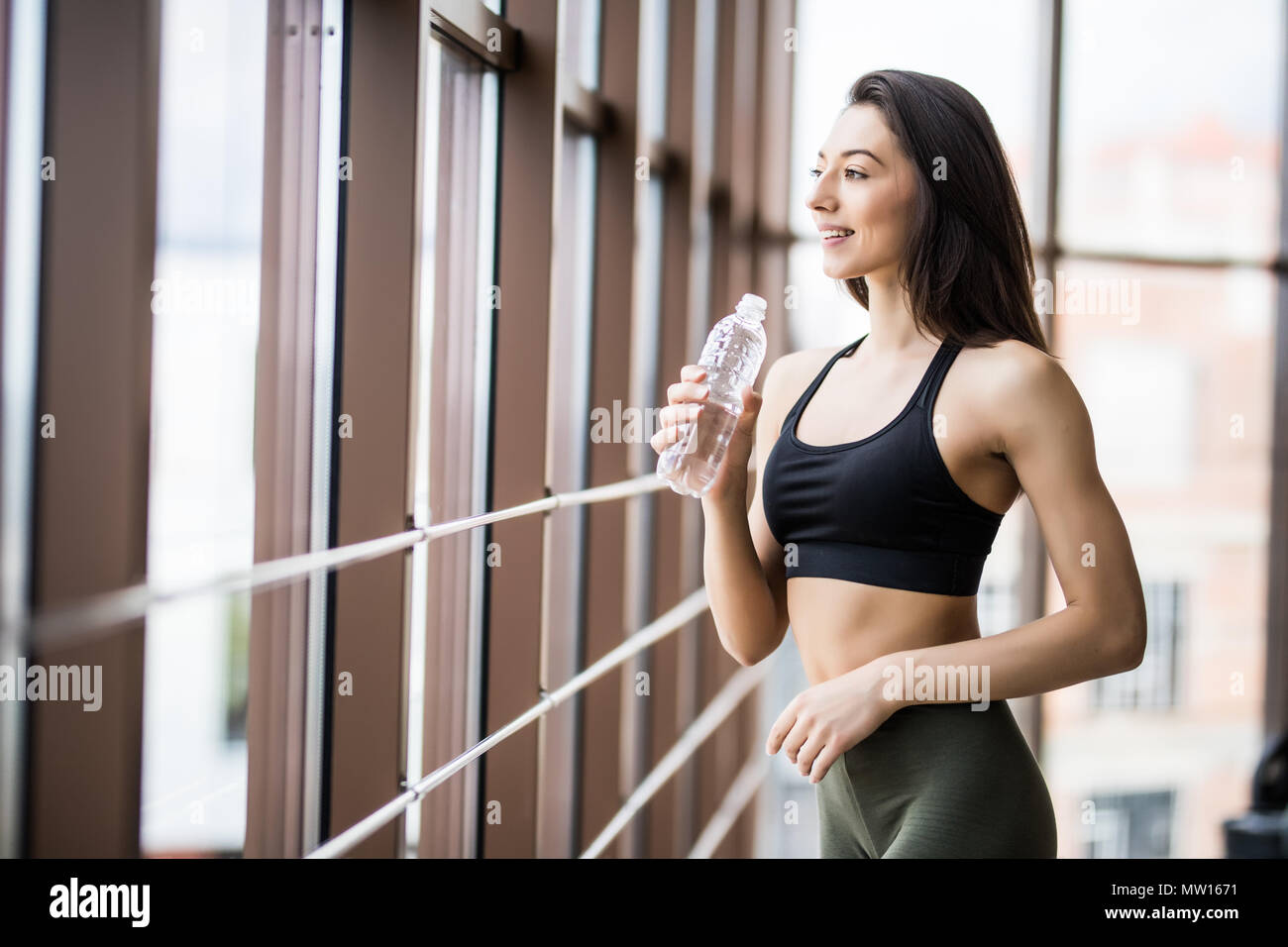 Silhouette woman holding water bottle hires stock photography and