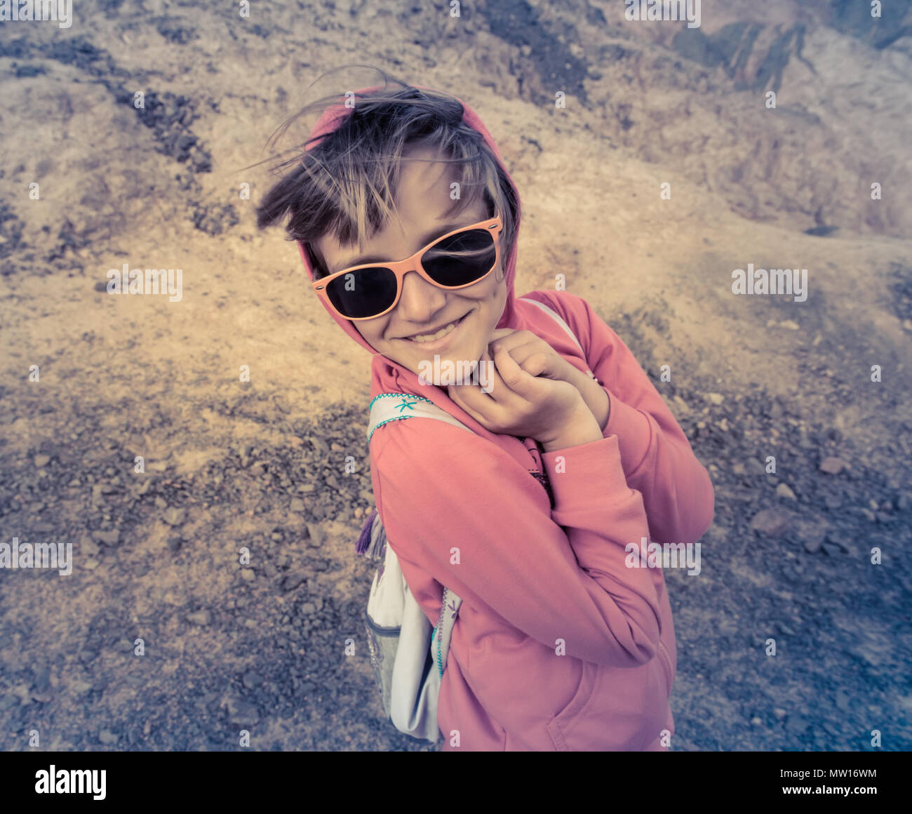 Young girl in sunglasses smiles and laughs at camera Stock Photo