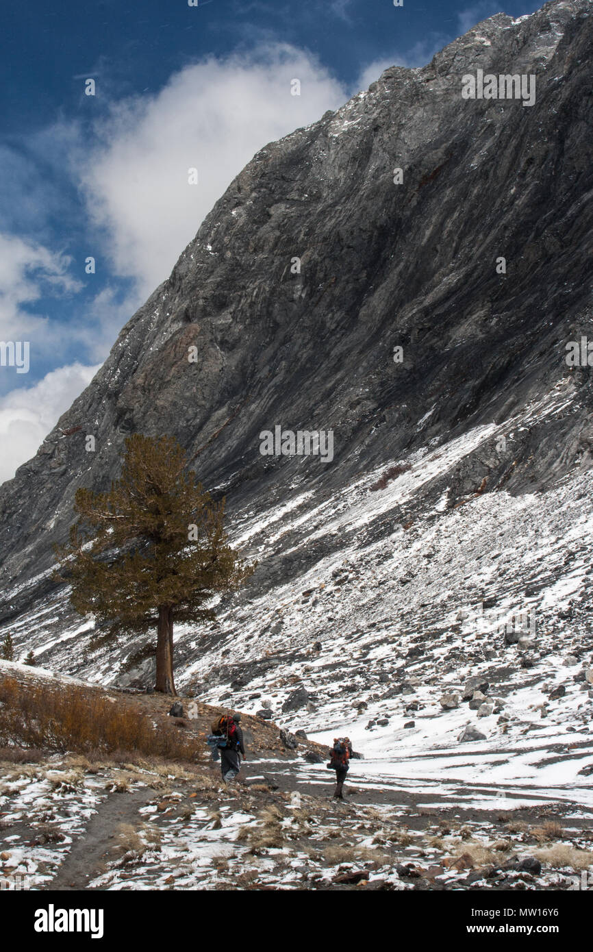People backpacking in the Sierra Nevada Mountains in California during winter. Stock Photo