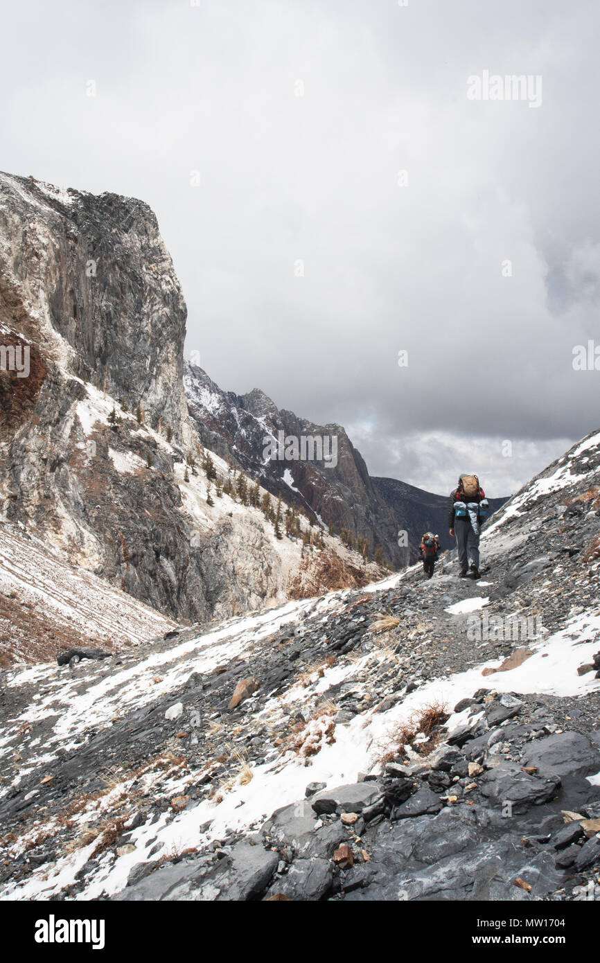 People backpacking in the Sierra Nevada Mountains in California during winter. Stock Photo