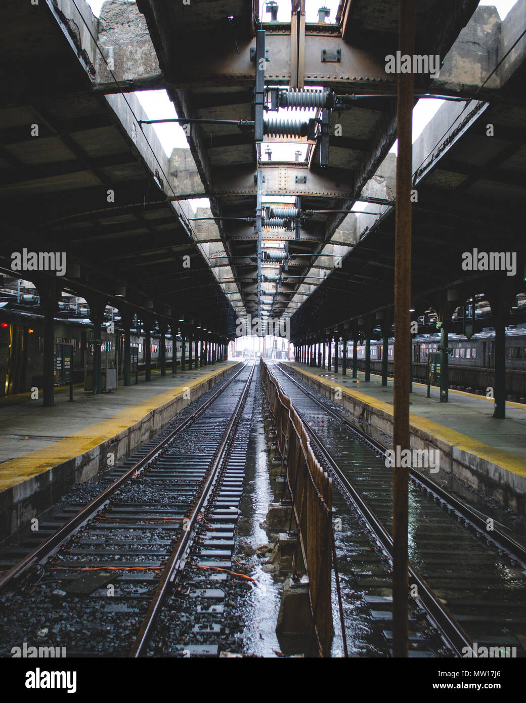 Hoboken Train Station platform and empty track wet from melting snow and rain Stock Photo