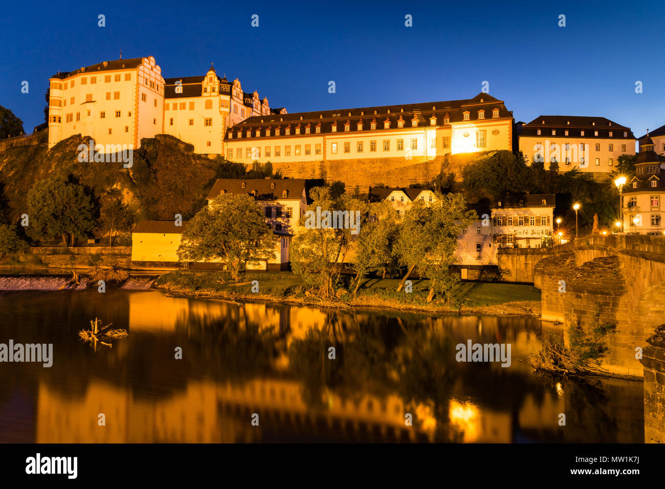 Weilburg Castle, reflection in the river Lahn, at night, Weilburg an der Lahn, Hesse, Germany Stock Photo