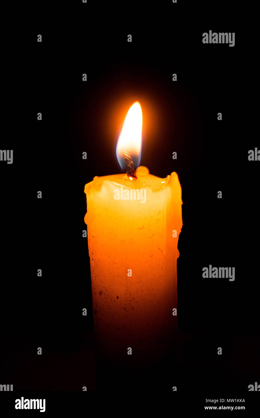Single lit candle with quite flame Stock Photo Alamy