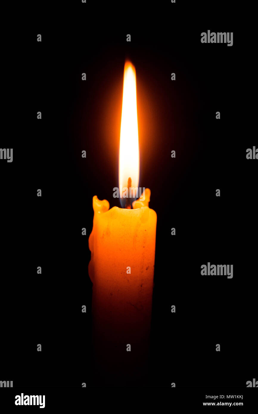 Single lit candle with quite flame Stock Photo Alamy