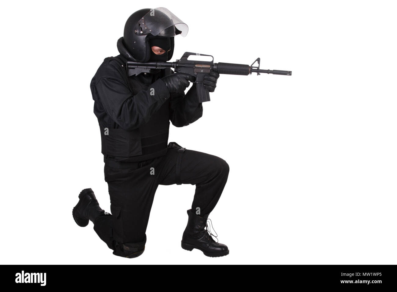 SWAT officer with assault rifle in black uniform isolated on white Stock Photo