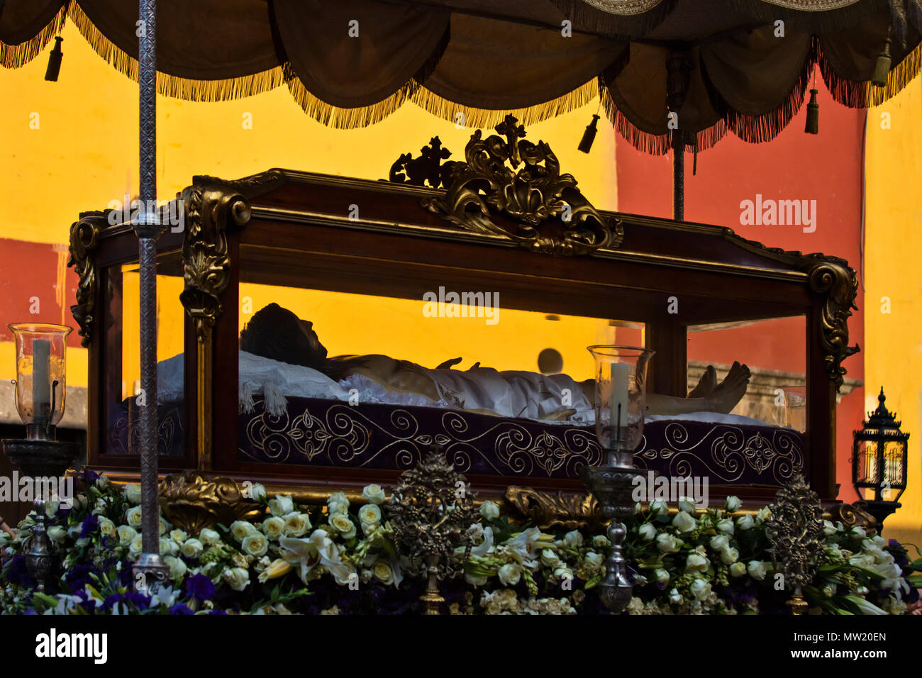 A statue of JESUS IN A COFFIN is carried in the Good Friday Procession ...