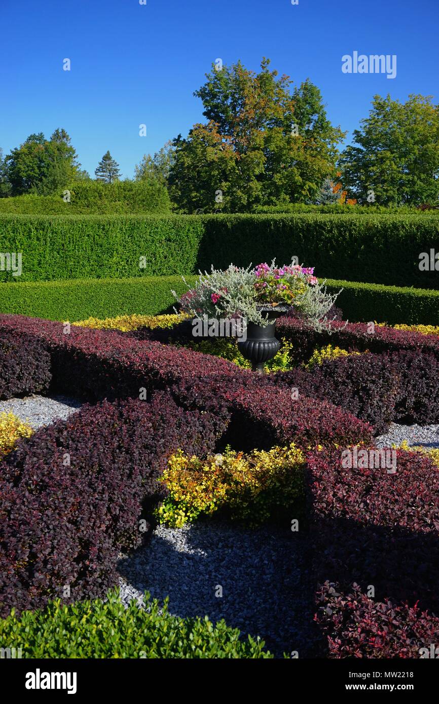 Saint Andrews, New Brunswick, Canada: Ornamental hedges and flowers at the Kingsbrae Botanical Gardens, on a sunny day. Stock Photo