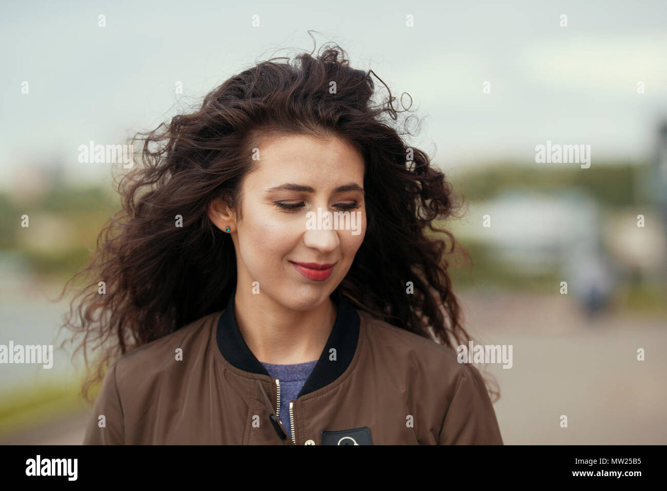 Portrait of attractive young brunette woman with long curly hair Stock ...
