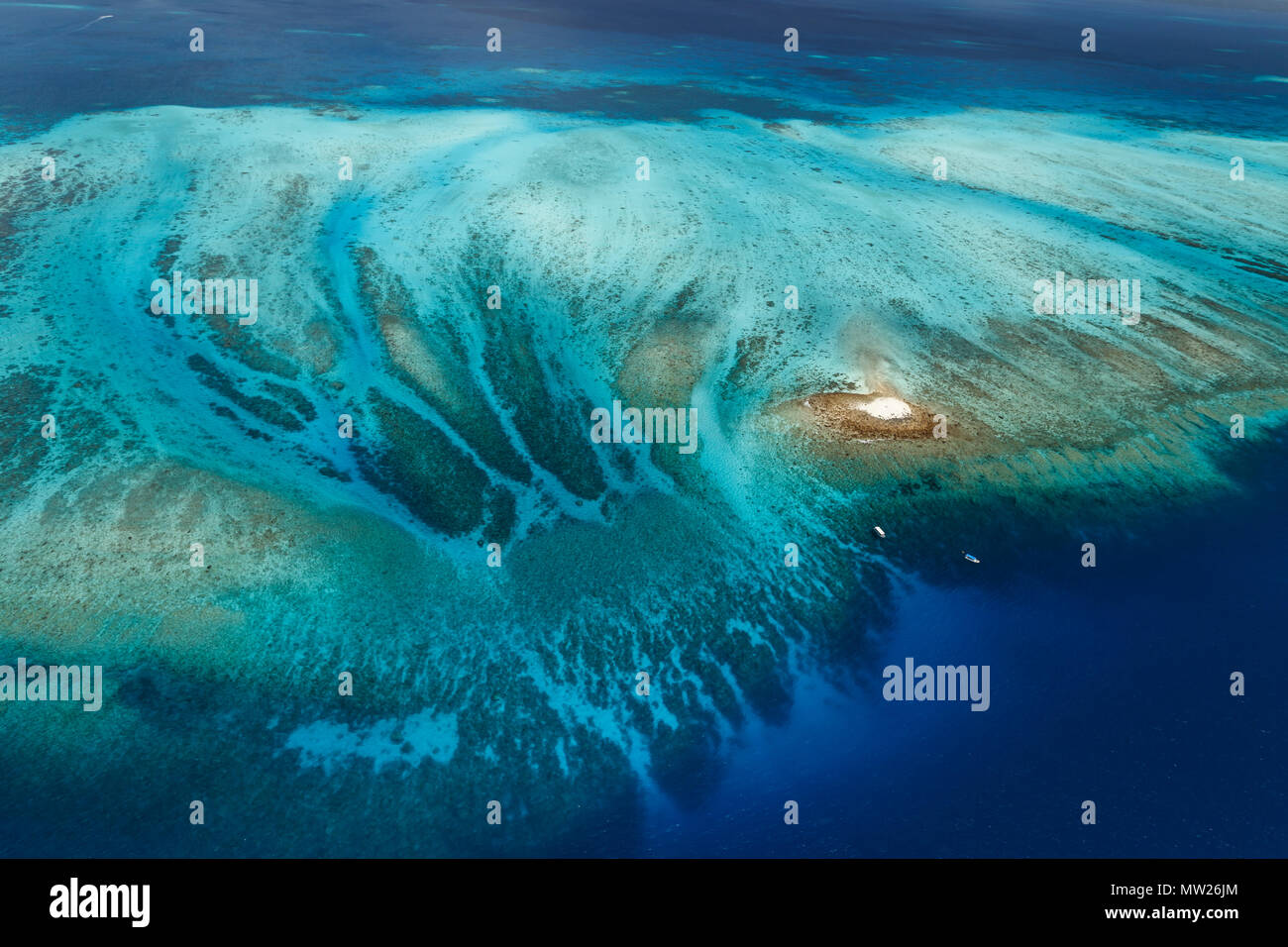 Arial view of a section of  barrier reef and the system of channels protecting a coral atoll Stock Photo