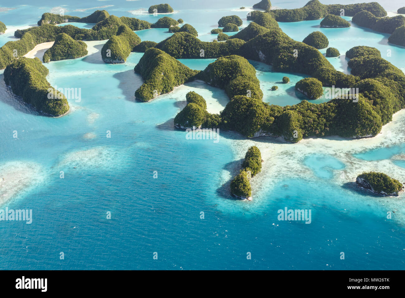 Aerial view of coral reefs, coral atolls, and islands surrounded by the