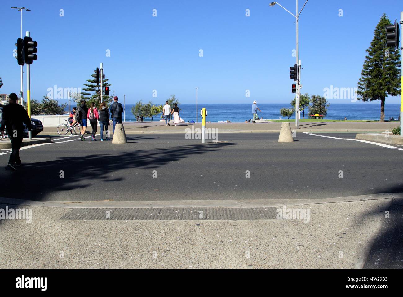 People crossing street at traffic intersection in Sydney. Pedestrians crossing road in Australia. Stock Photo