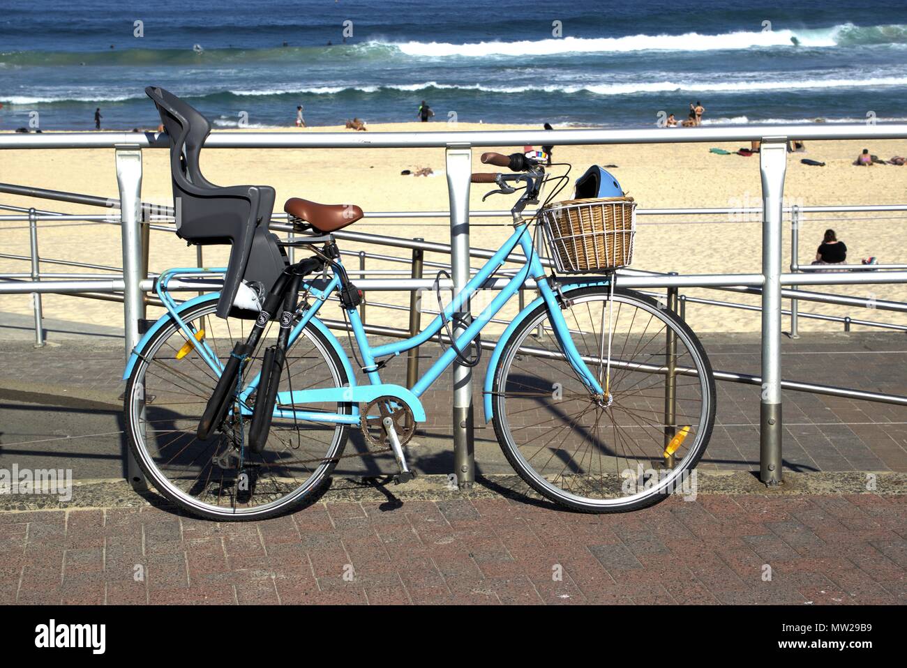 Locked bicycle parked at Bondi beach Sydney Australia. Bicycle with baby seat fitted on it outdoors. Stock Photo