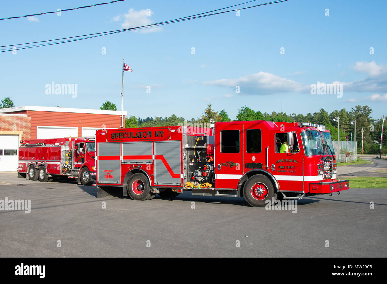 Two fire engines from the Speculator Volunteer Fire Department, in Speculator, NY USA, driving out on a training exercise. Stock Photo