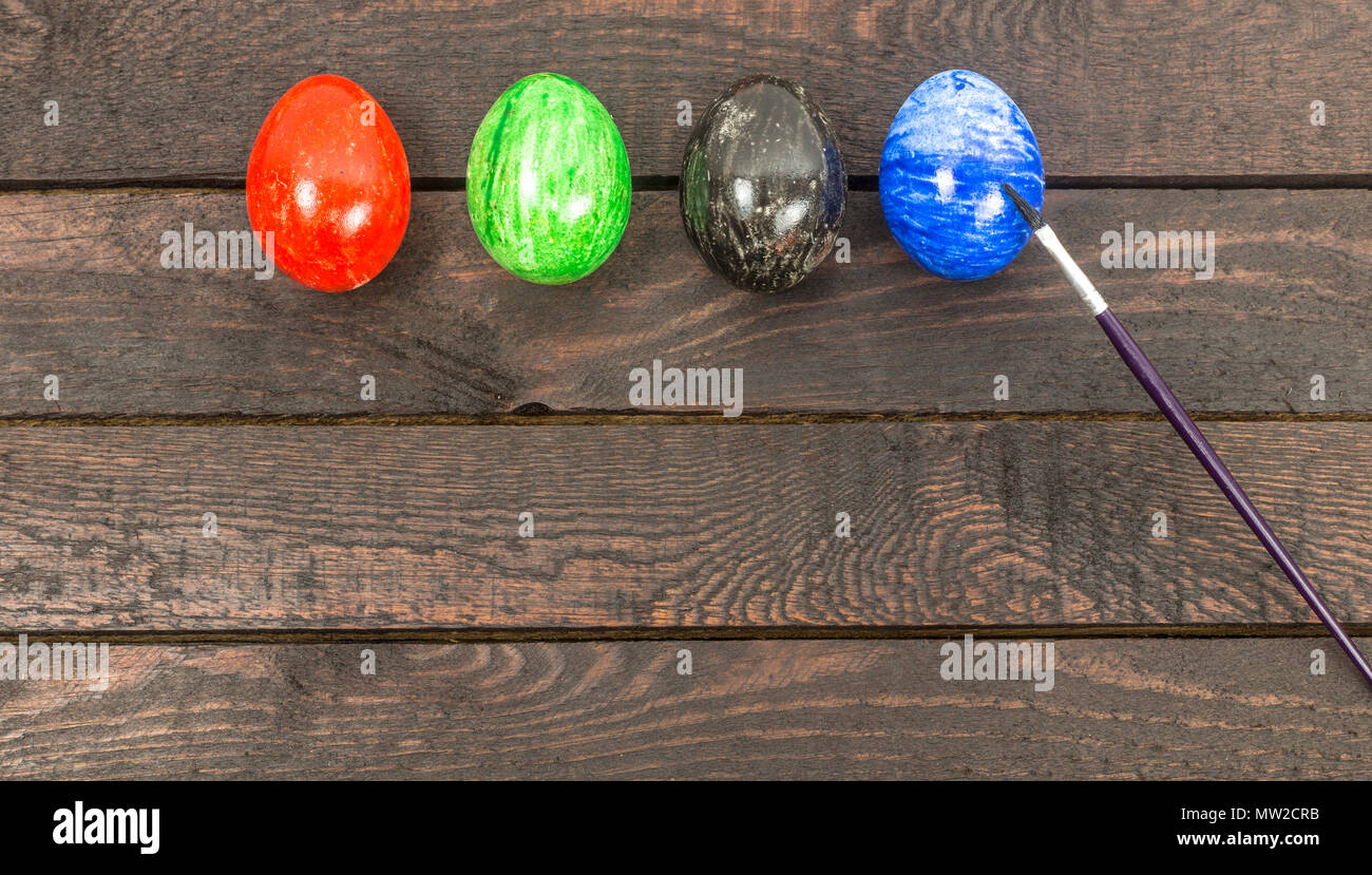 colouring eggs with brush for eastertime at home. Stock Photo