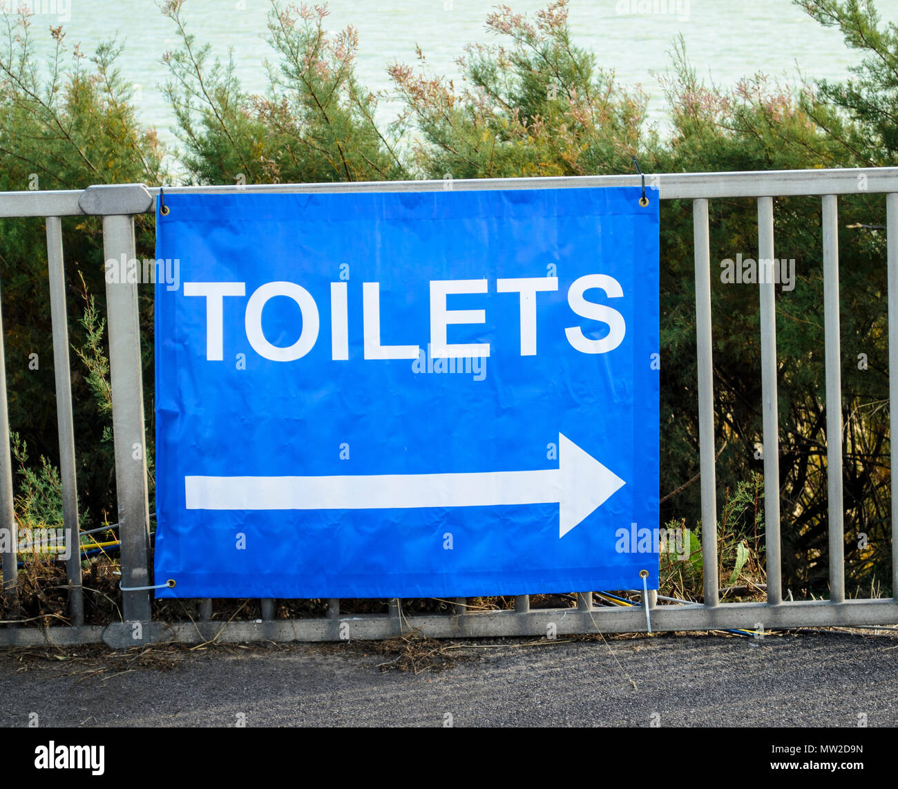 arrow pointing the way to the public toilets, UK Stock Photo