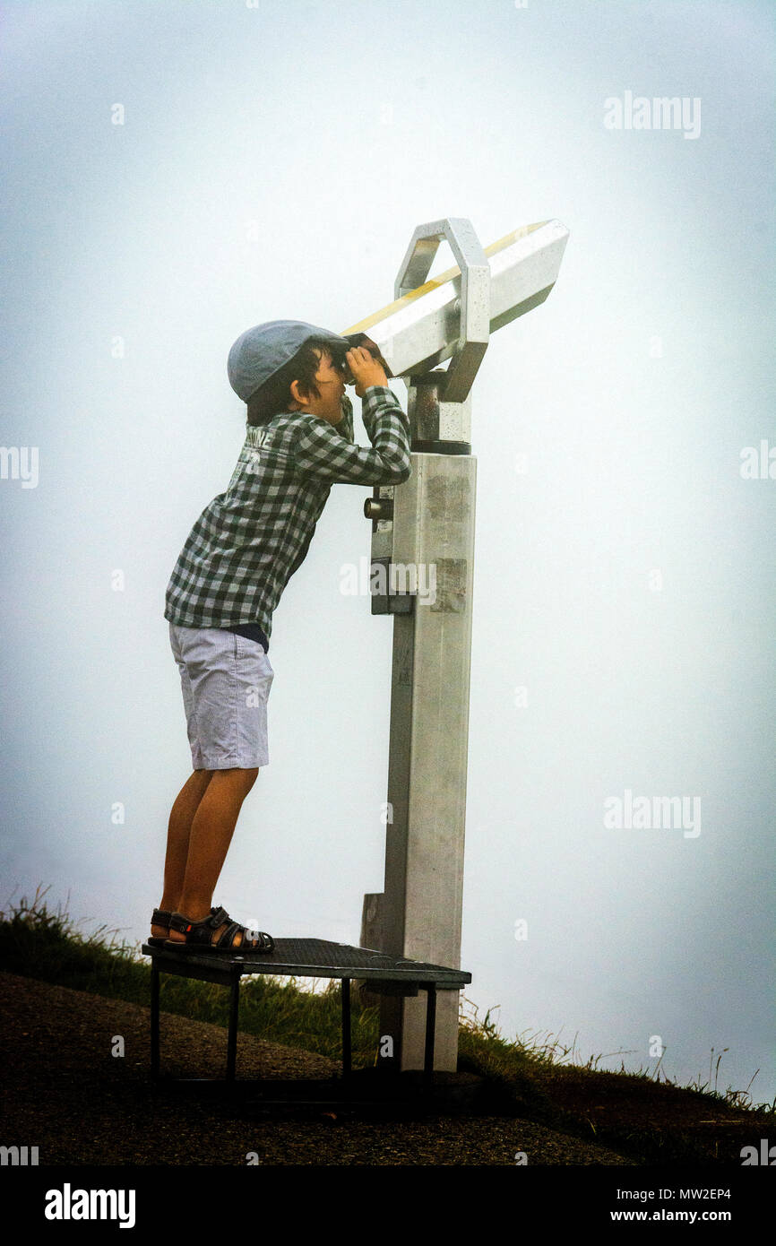 Child looking at a telescope, Puy de Dome volcano, Auvergne, France Stock Photo