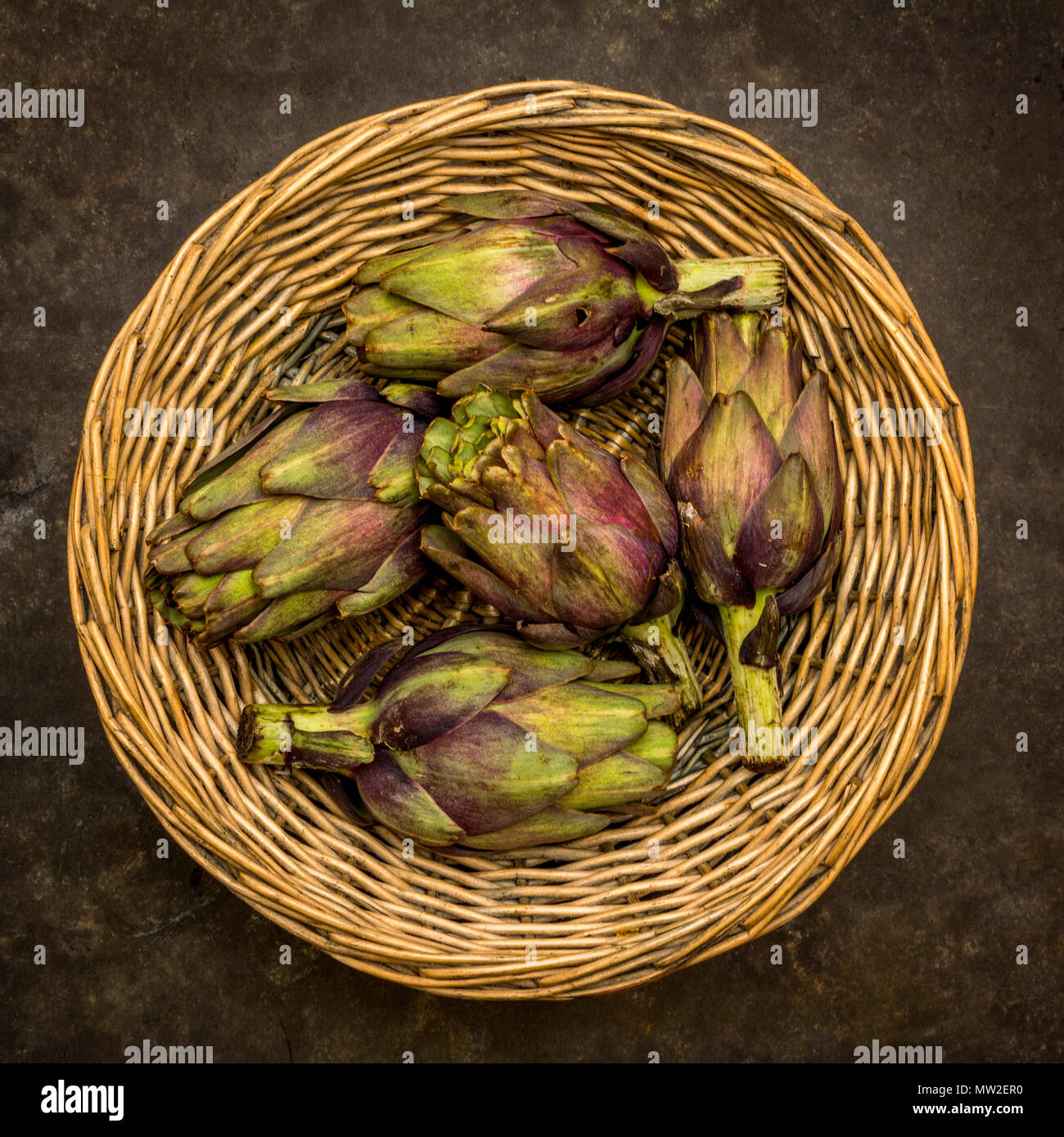 Artichokes in a wicker basket. Stock Photo