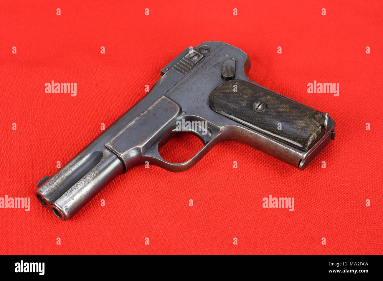 Old rusty handgun on red background Stock Photo - Alamy