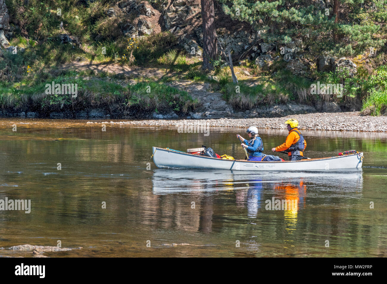 RIVER SPEY SPEYSIDE TAMDHU SCOTLAND CANOE CANOEIST GREY CANOE WITH TWO PEOPLE ON THE RIVER IN SPRING Stock Photo