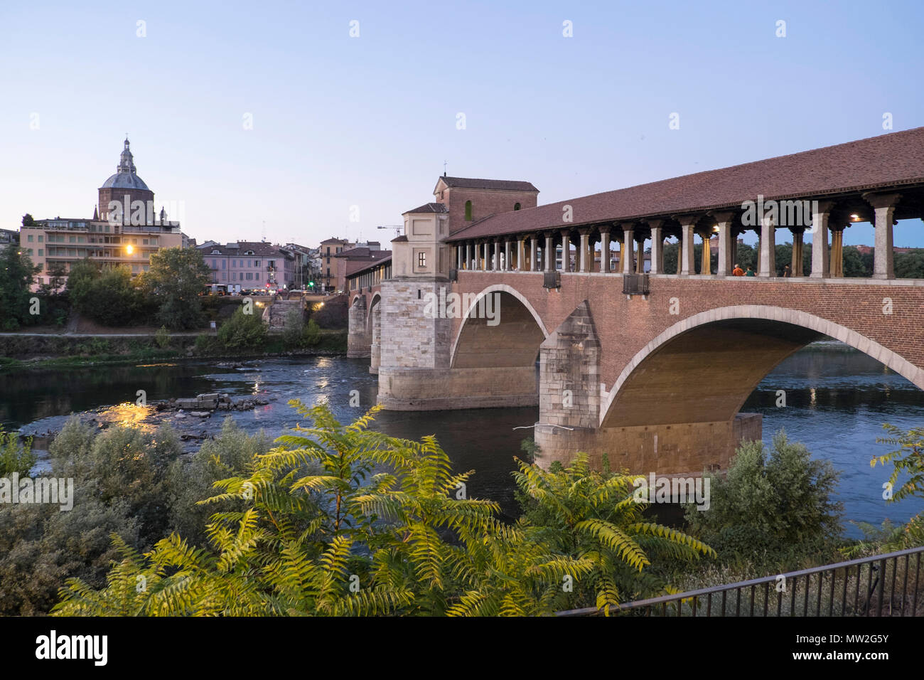 Italy, Lombardy, Pavia: the 'Ponte Corto' covered bridge across the Ticino river. In the background, the cathedral Stock Photo