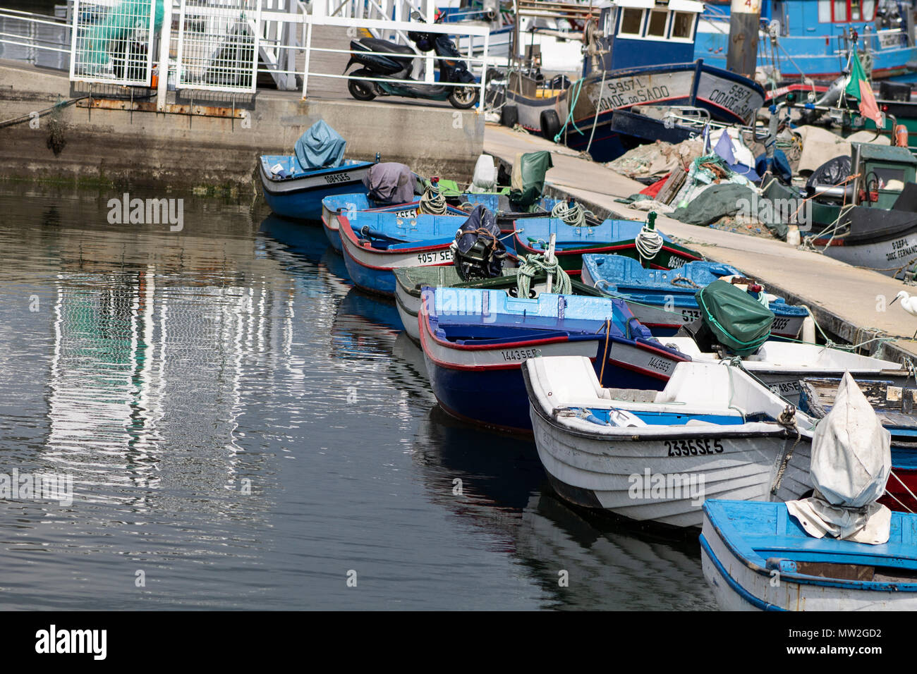 small fishing boats moored in port of many colors Stock Photo