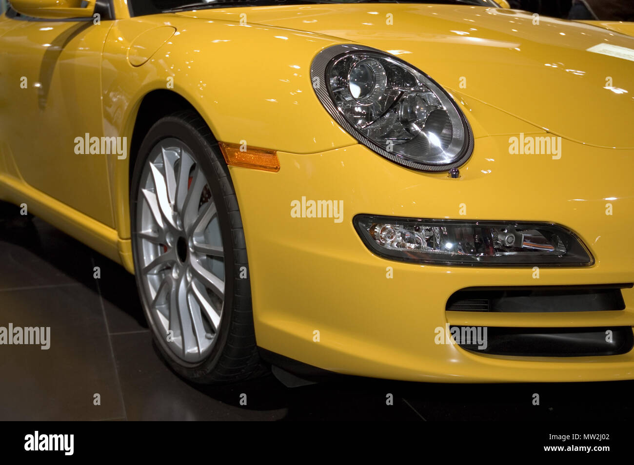 Close-up look at the front fender and headlight assembly of a yellow sports car. Many more car photos available in my gallery. Stock Photo