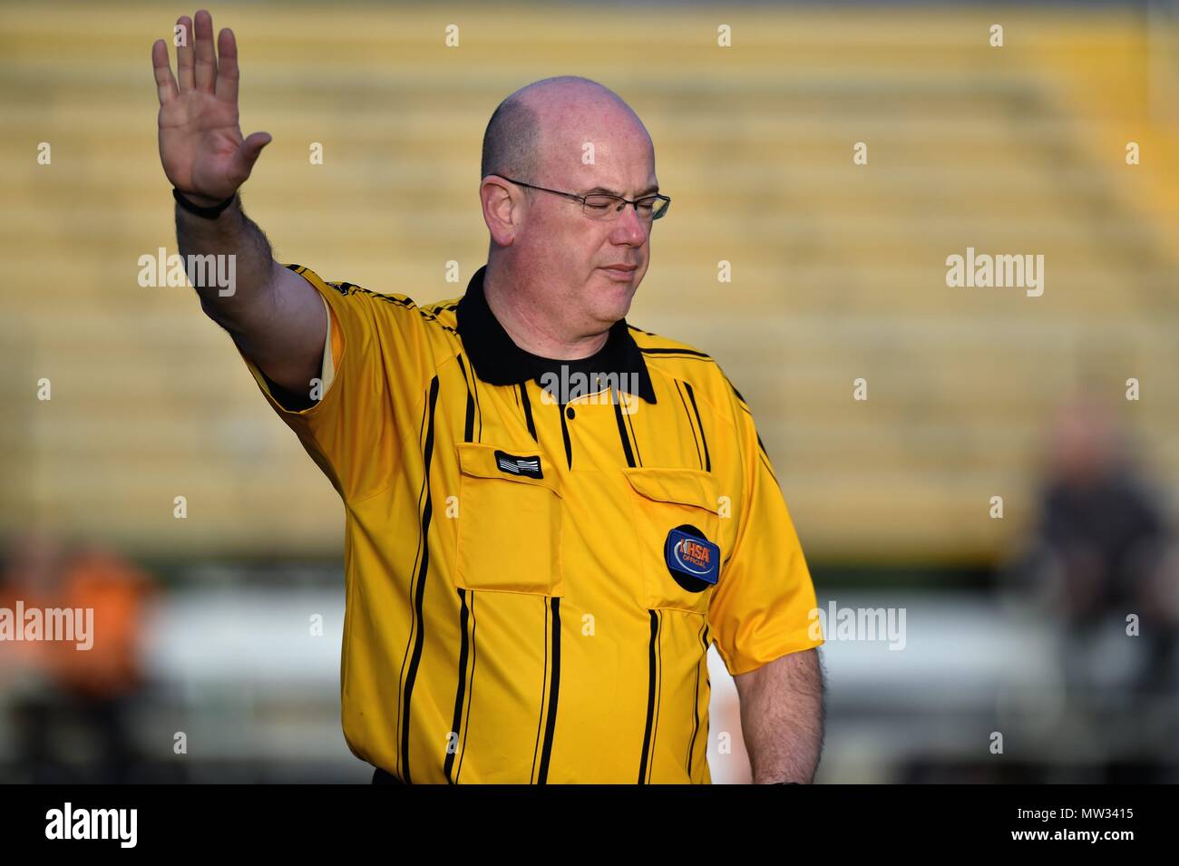Referee gesturing during a high school soccer match. USA. Stock Photo