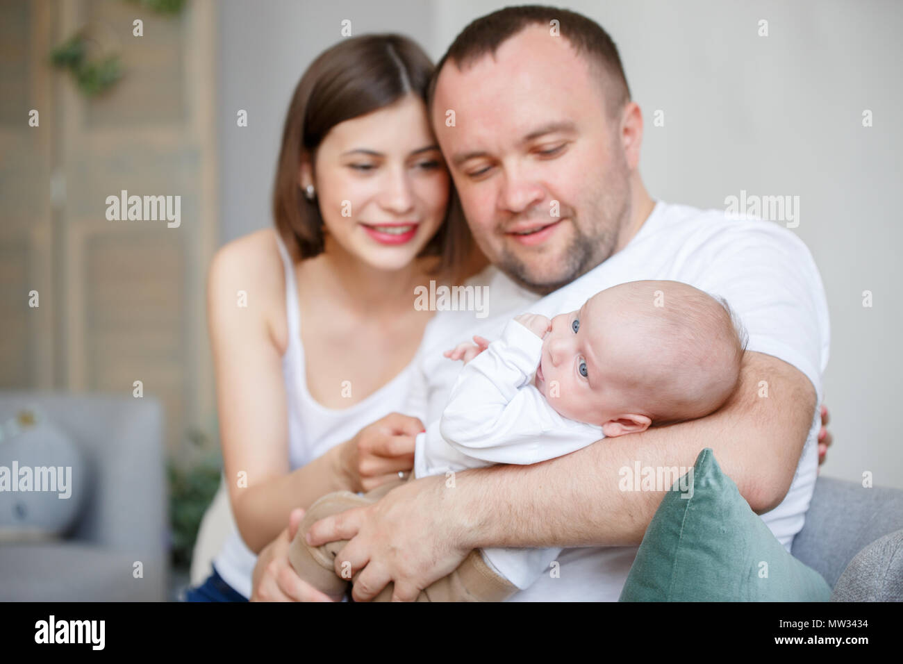 Picture of cuddling parents with newborn son Stock Photo - Alamy