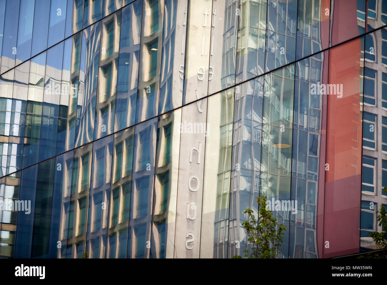 Manchester city centre Astley House reflects in the window of Allied London landmark offices  No.1 Spinningfields Stock Photo