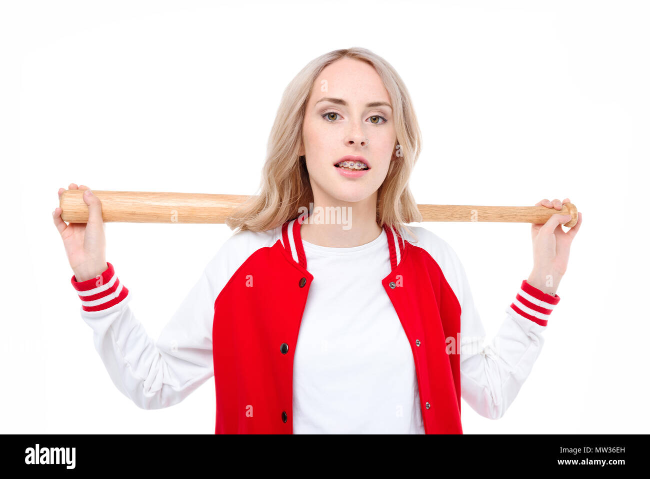 Three quarter length shot of a young woman holding a baseball bat behind her shoulders. Stock Photo