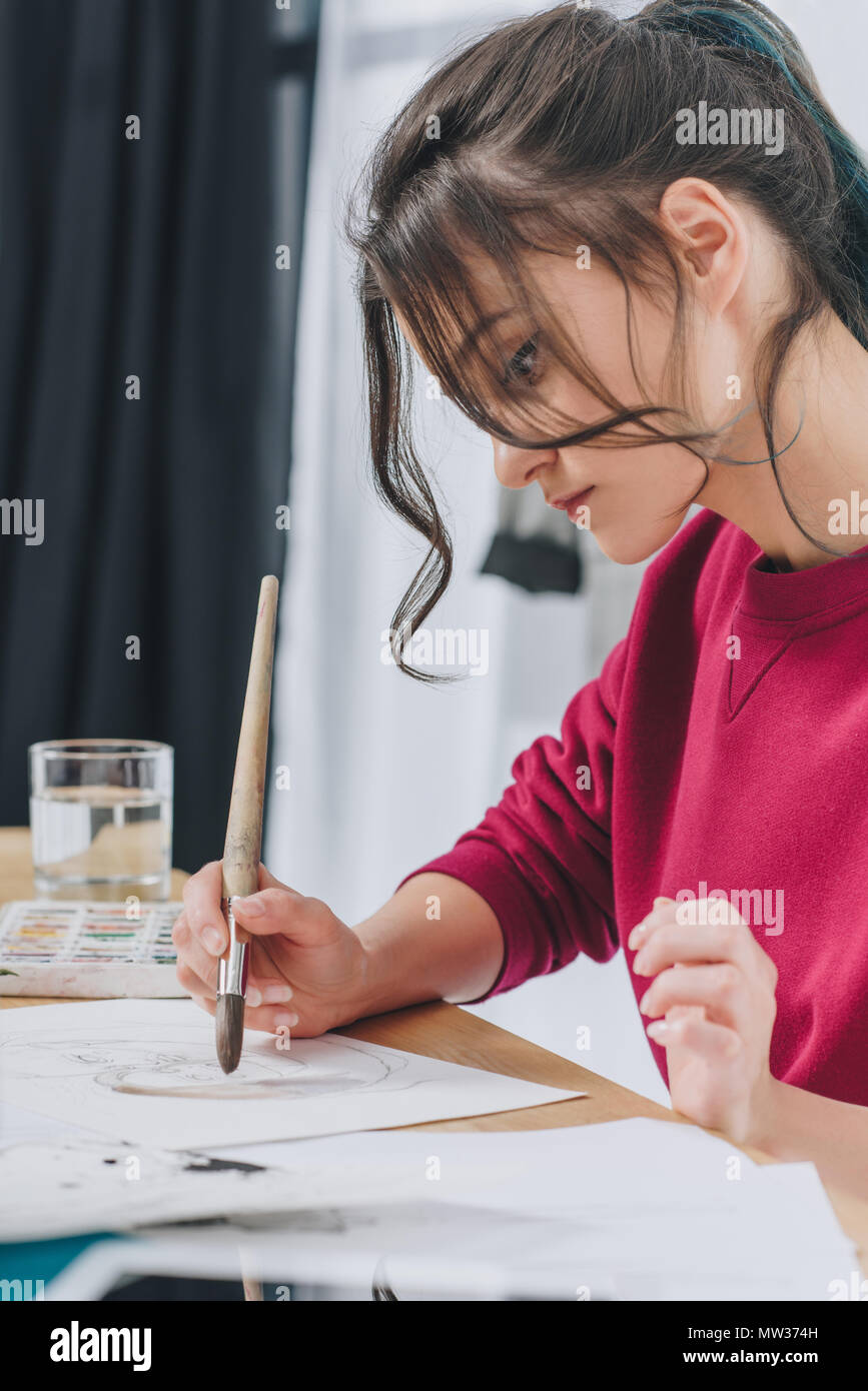 Female designer drawing with large brush Stock Photo