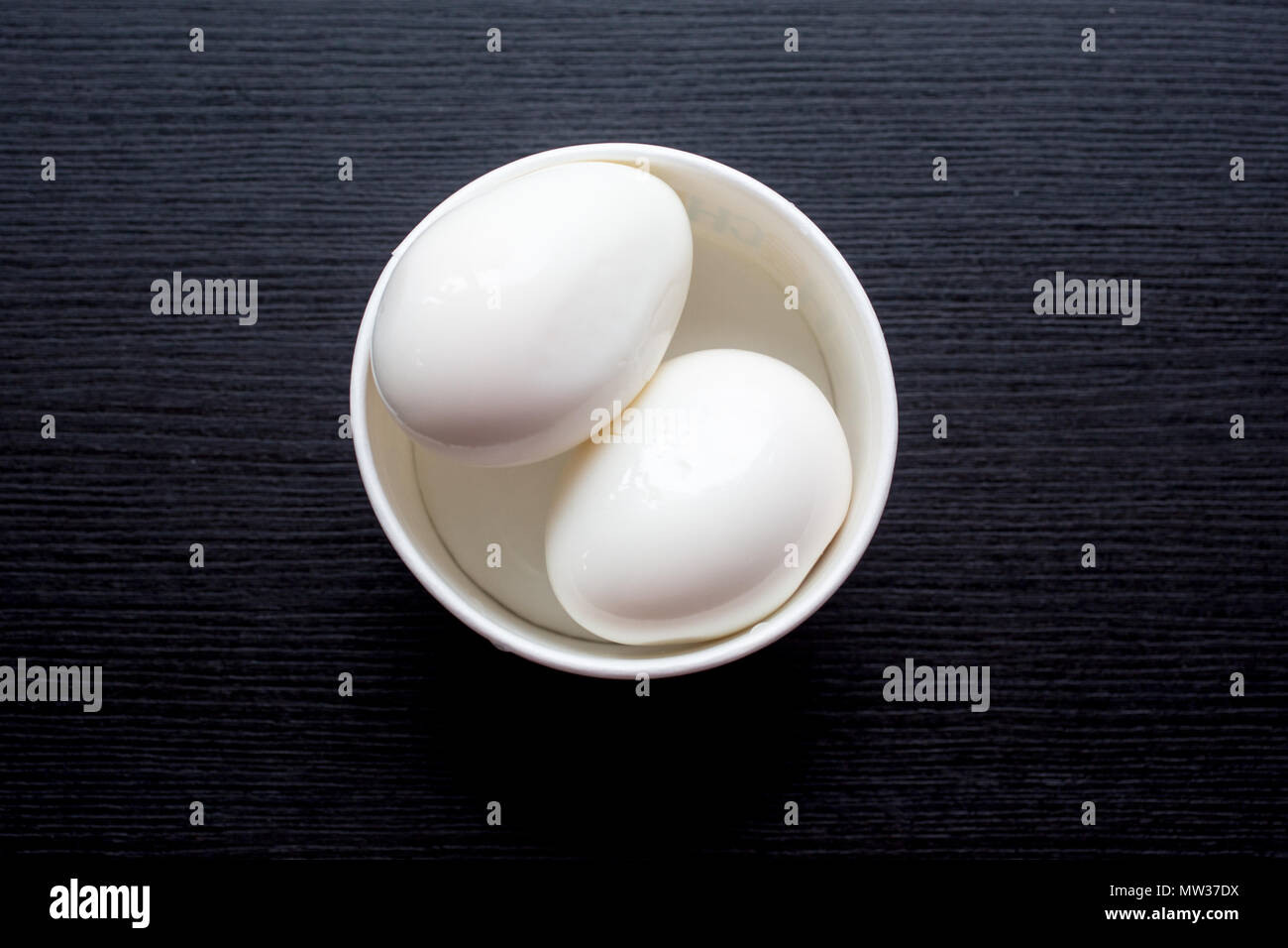 Two boiled eggs in a double egg cup Stock Photo - Alamy