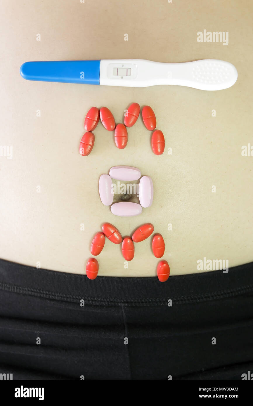 medicine vitamin and pregnancy test on belly woman Stock Photo Alamy