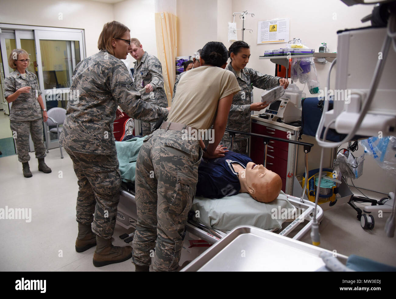 Members of the 81st Medical Operations Squadron participate in a medical emergency scenario during Code Blue Thursday in the Keesler Medical Center emergency room April 27, 2017, on Keesler Air Force Base, Miss. Emergency room staff members coordinated with the simulation lab to use human patient simulators for running various advanced cardiac life support scenarios to improve Keesler’s new medical technicians’ skills and get them familiar with emergency equipment. Stock Photo