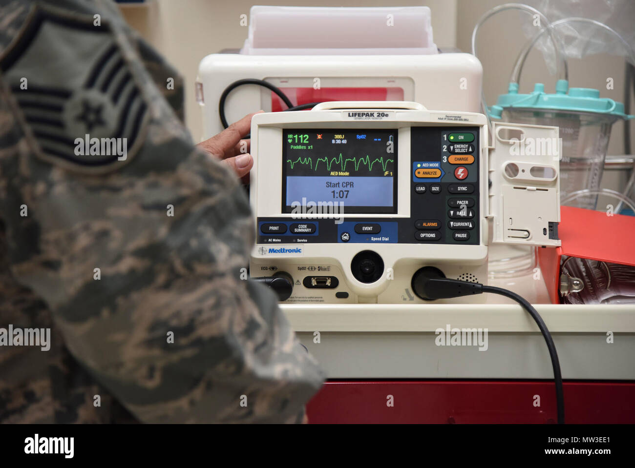 Master Sgt. Juan Diaz, 81st Medical Operations Squadron medical technician, operates a defibrillator during Code Blue Thursday in the Keesler Medical Center emergency room April 27, 2017, on Keesler Air Force Base, Miss. Emergency room staff members coordinated with the simulation lab to use human patient simulators for running various advanced cardiac life support scenarios to improve Keesler’s new medical technicians’ skills and get them familiar with emergency equipment. Stock Photo