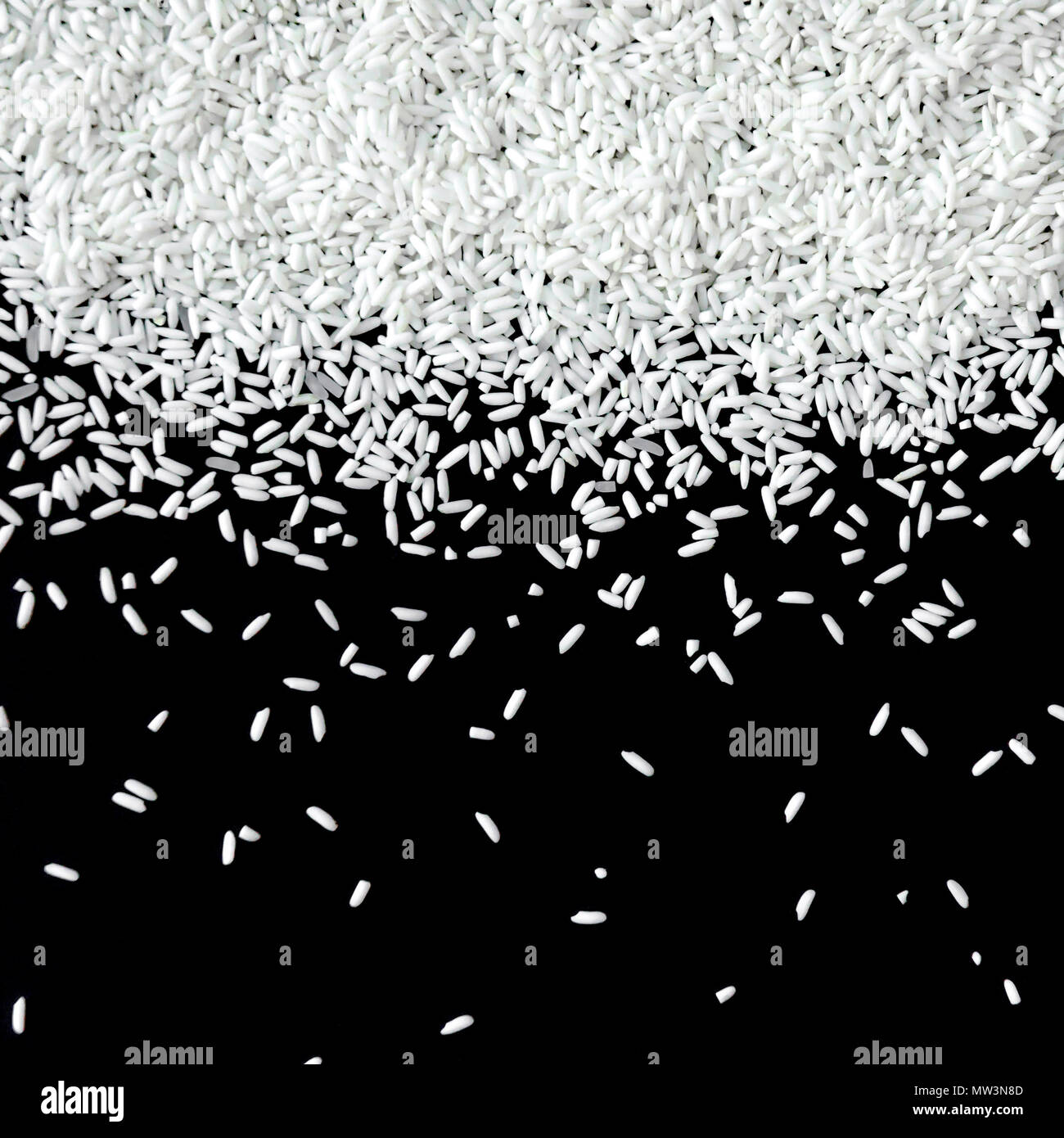 Pile of rice seed on the black background for isolated, Brown of rice grain and close-up of rice pile Stock Photo