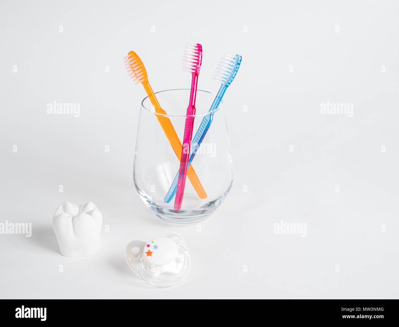The pacifier, the tooth and the toothbrush, the dental health from birth Stock Photo