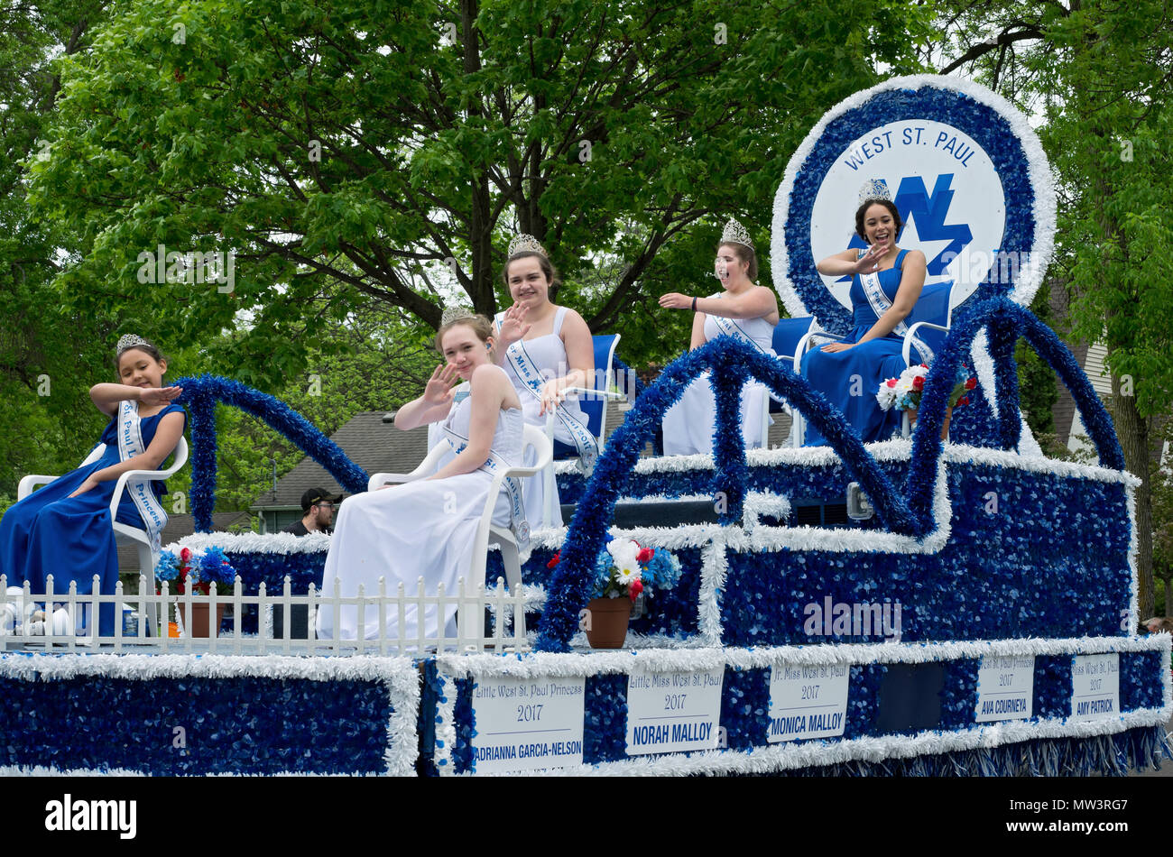 West Saint Paul, Minnesota, USA – MAY 19, 2018: Royalty of West Saint Paul waves to crowd from atop float at annual West Saint Paul Days parade. Stock Photo