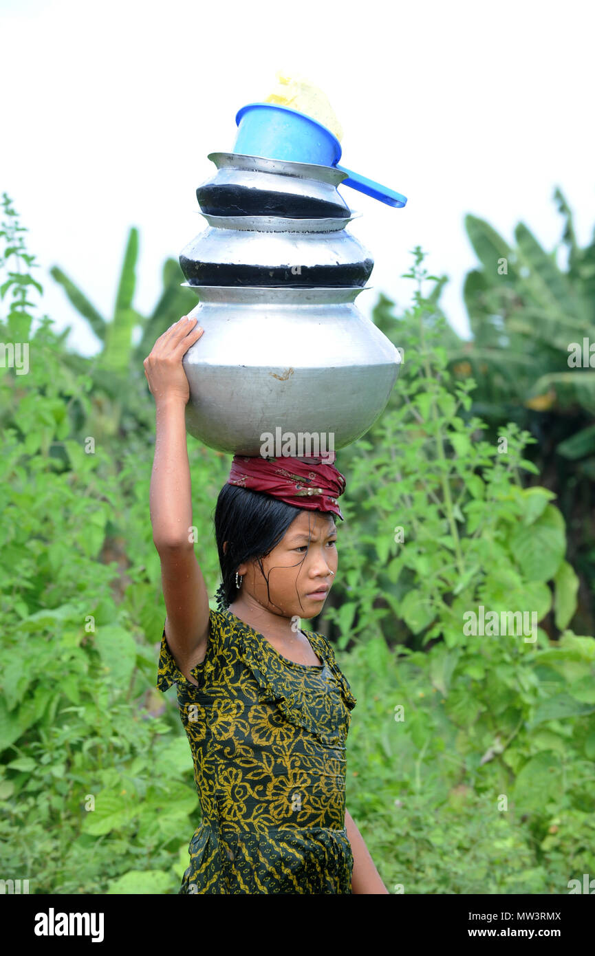 Rangamati, Bangladesh, - October 17, 2011: Tribe girls carry water from springs and wells in the remote Sajek Valley of Rangamati in Bangladesh. Stock Photo