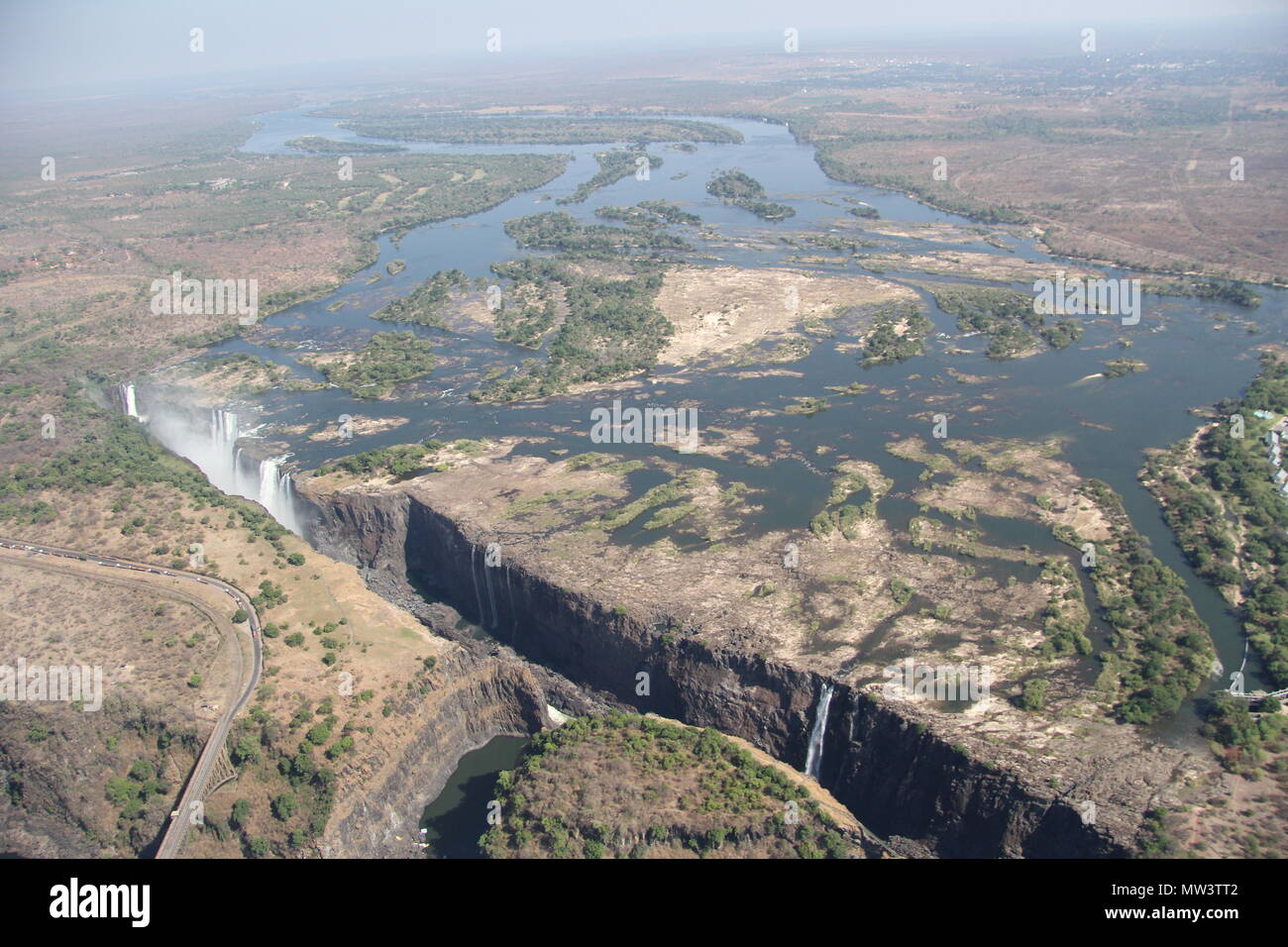 Spray of the Victoria Falls waterfall aerial shots from helicopter Stock Photo