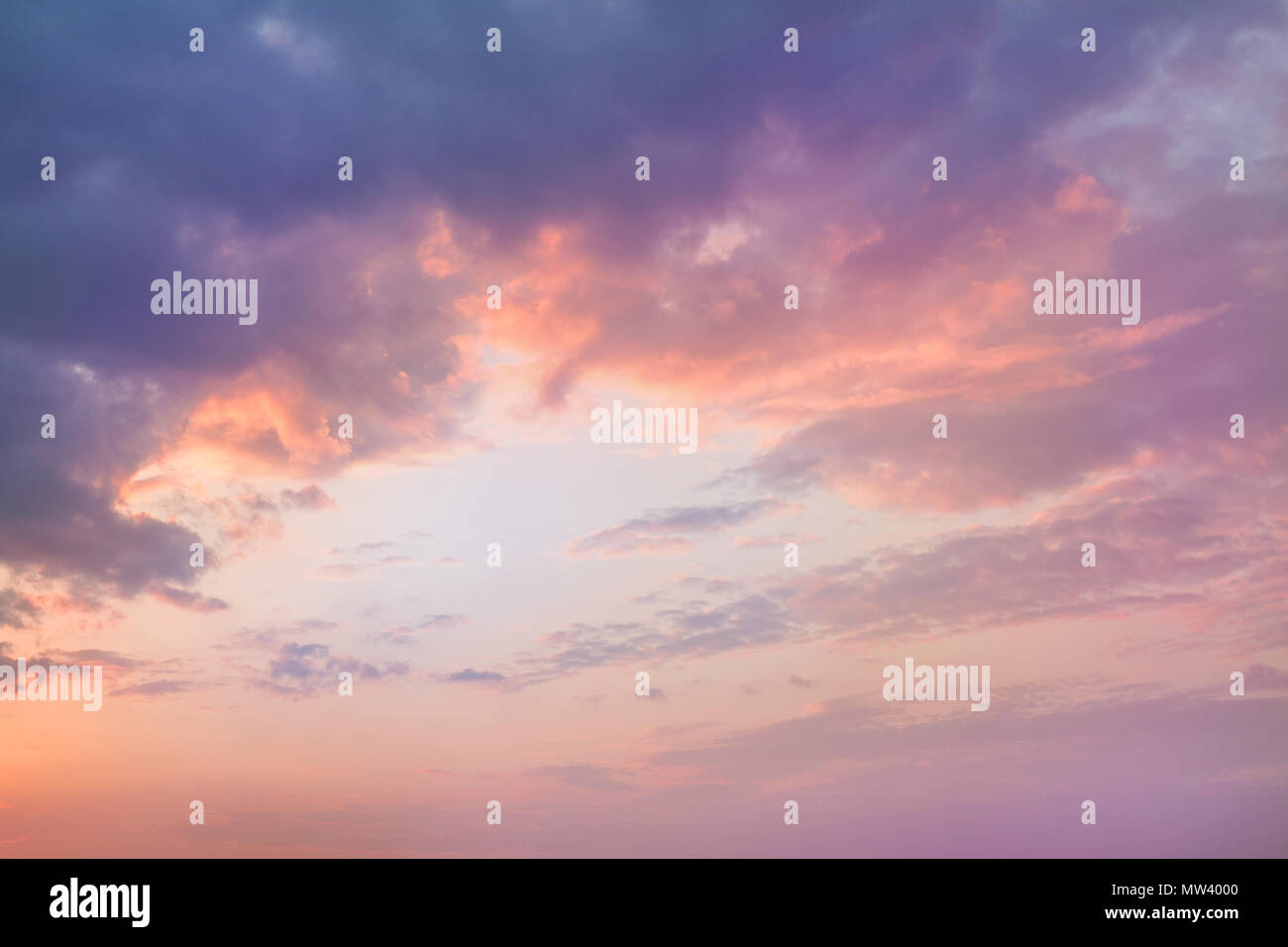 Colorful vibrant dramatic sky with purple to orange clouds. Sunset time ...