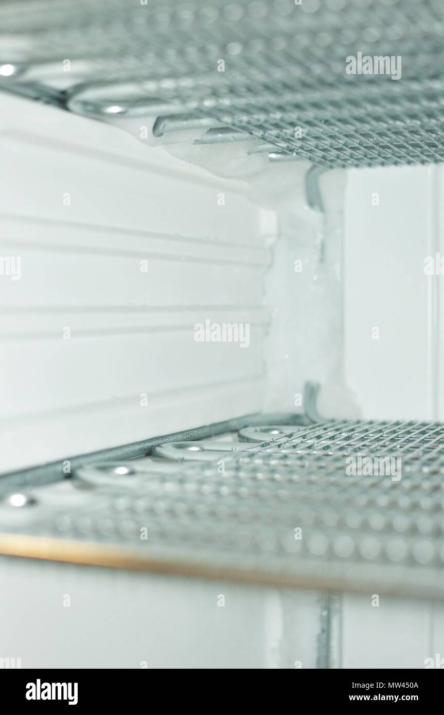 Freezer Inner Look Inside the freezer while defrosted, front view Stock Photo - Alamy