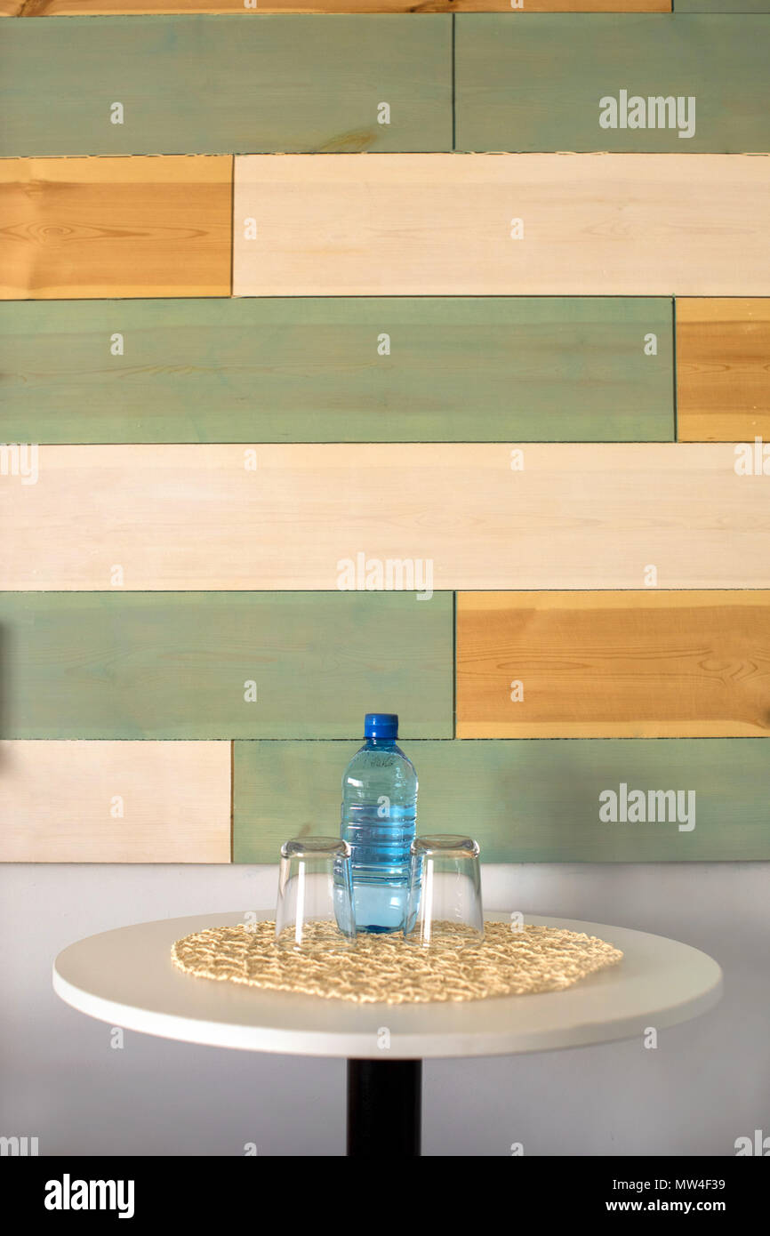 Bottle of water with glasses on table Stock Photo