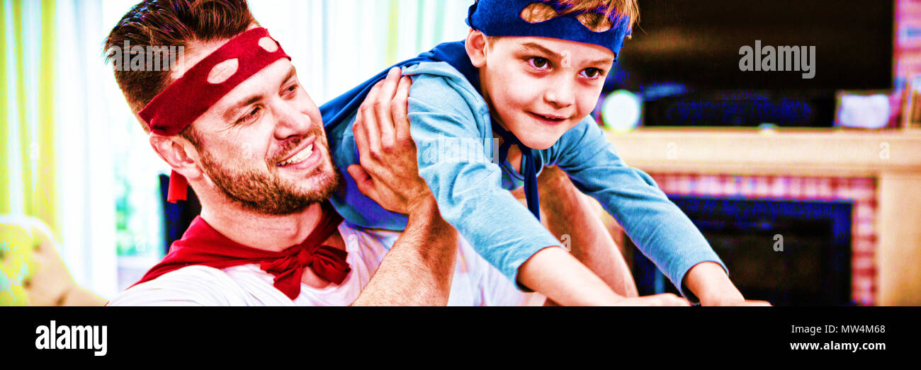 Father and son pretending to be superhero Stock Photo