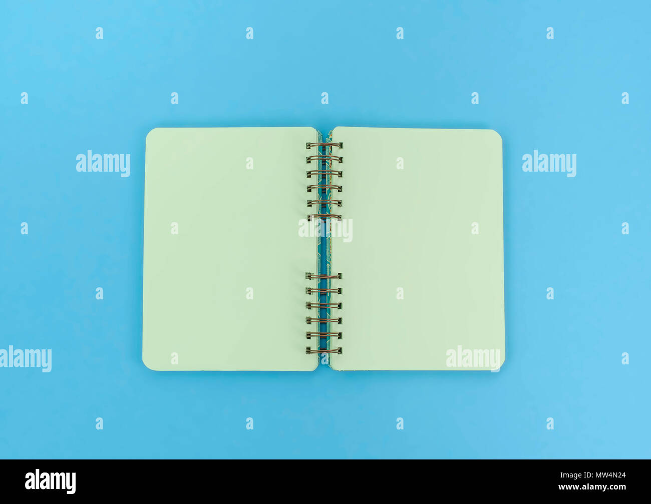 Open notebook for notes is on the surface. The pastel blue background copy space Stock Photo